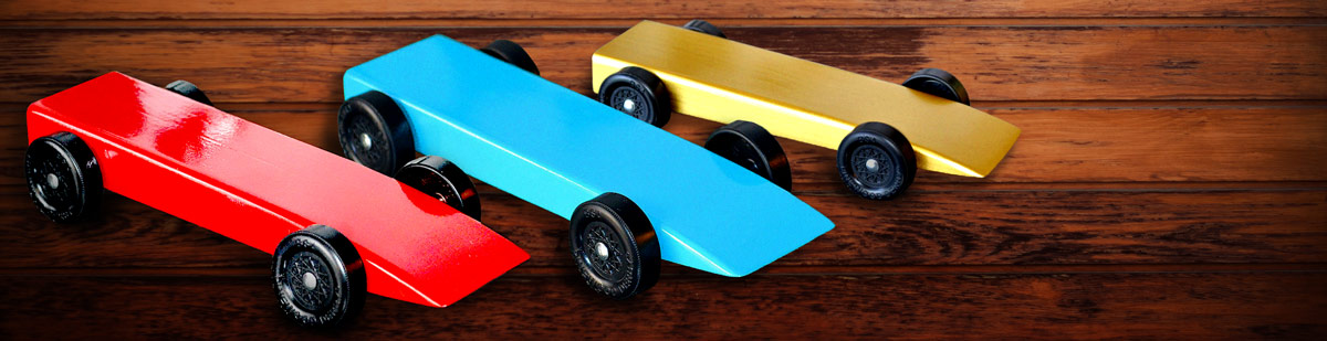 Cub Scout pack pinewood derby planning guide header image showing a pinewood derby in background with derbies made easy ebook in front