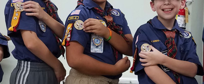 hand placement of patrol patch placement on Webelos scout uniform